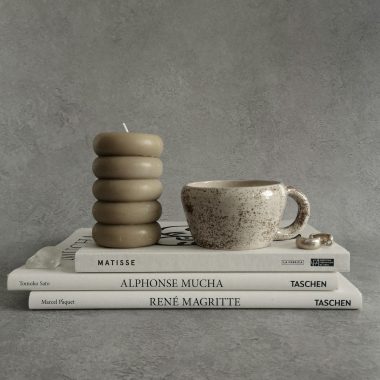 a stack of books and a cup