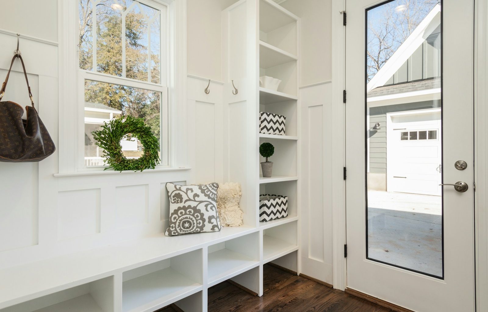 gray and white floral throw pillow beside rack inside room