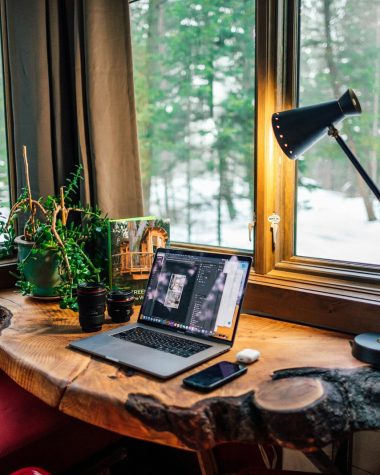 black and gray laptop computer beside black smartphone