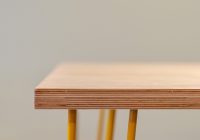 brown wooden table with yellow steel frame