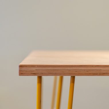 brown wooden table with yellow steel frame