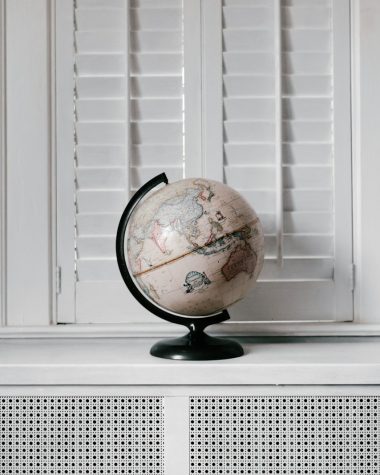 beige desk globe on white desk