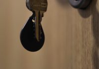 A bunch of keys hanging from a door handle