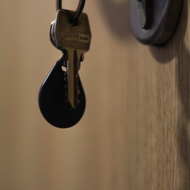 A bunch of keys hanging from a door handle