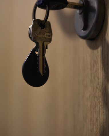 A bunch of keys hanging from a door handle