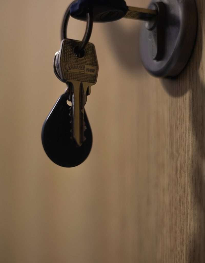 A bunch of keys hanging from a door handle