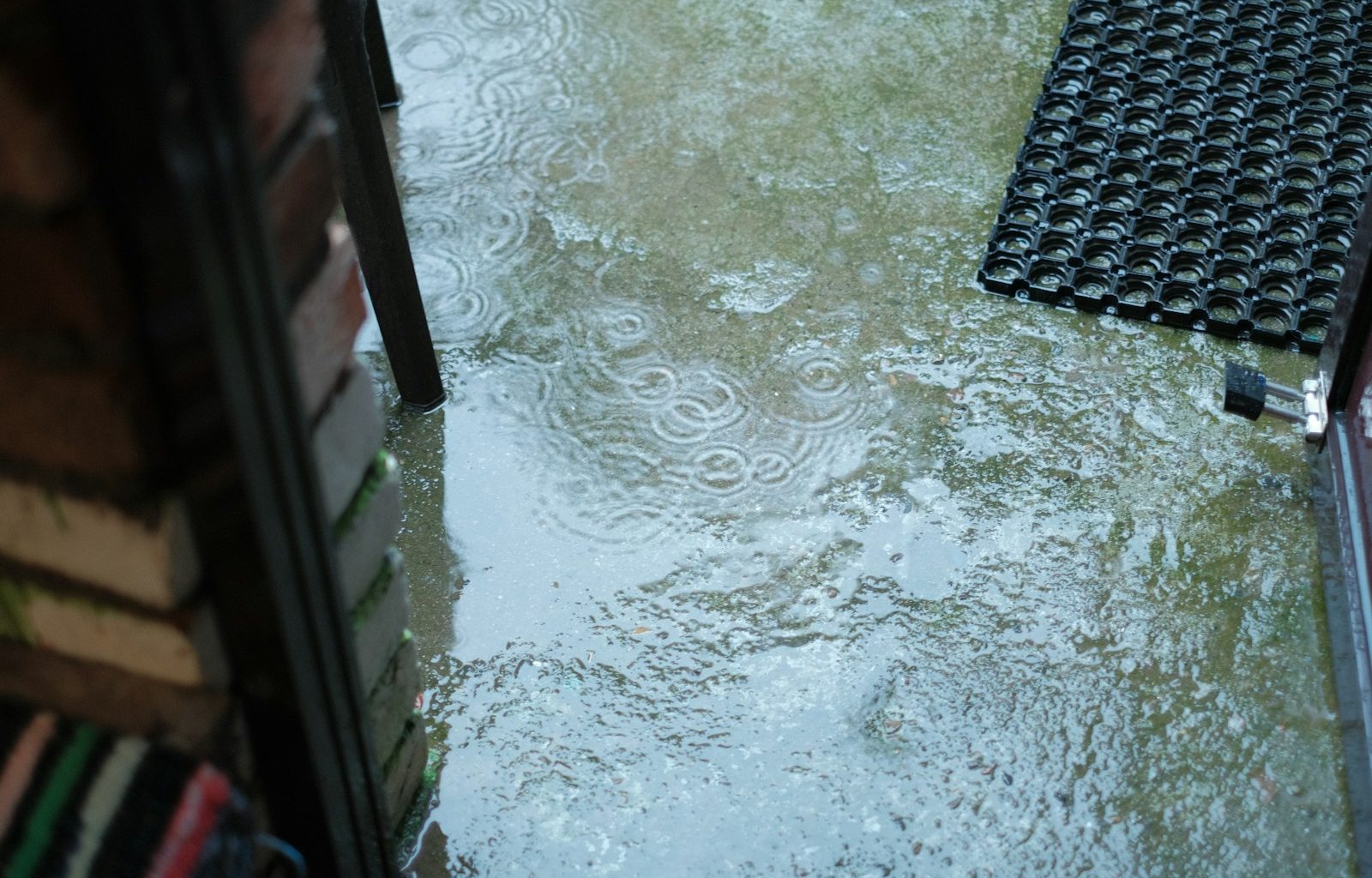 a door is partially submerged in a puddle of water