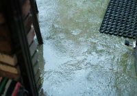 a door is partially submerged in a puddle of water