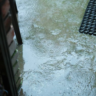a door is partially submerged in a puddle of water