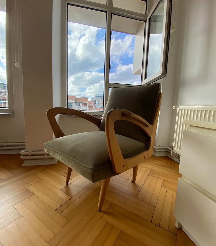 a chair sitting on a hard wood floor in front of a window