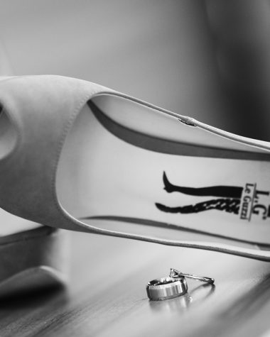 Witte bruidsschoenen met een elegante lage hak op een houten vloer